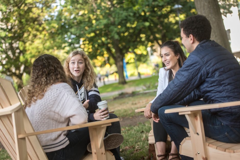 A group of students chatting together outside.