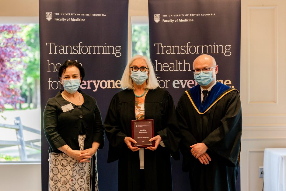 Patti Erlendson receives her promotion from Sue Forwell and Acting Dean of Faculty Roger Wong at the May 2022 Academic Gown event