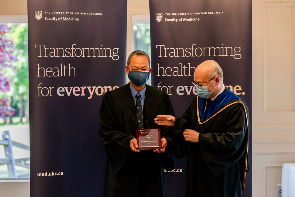 Michael Lee receiving his promotion from Acting Dean of Faculty Roger Wong at the May 2022 Academic Gown event