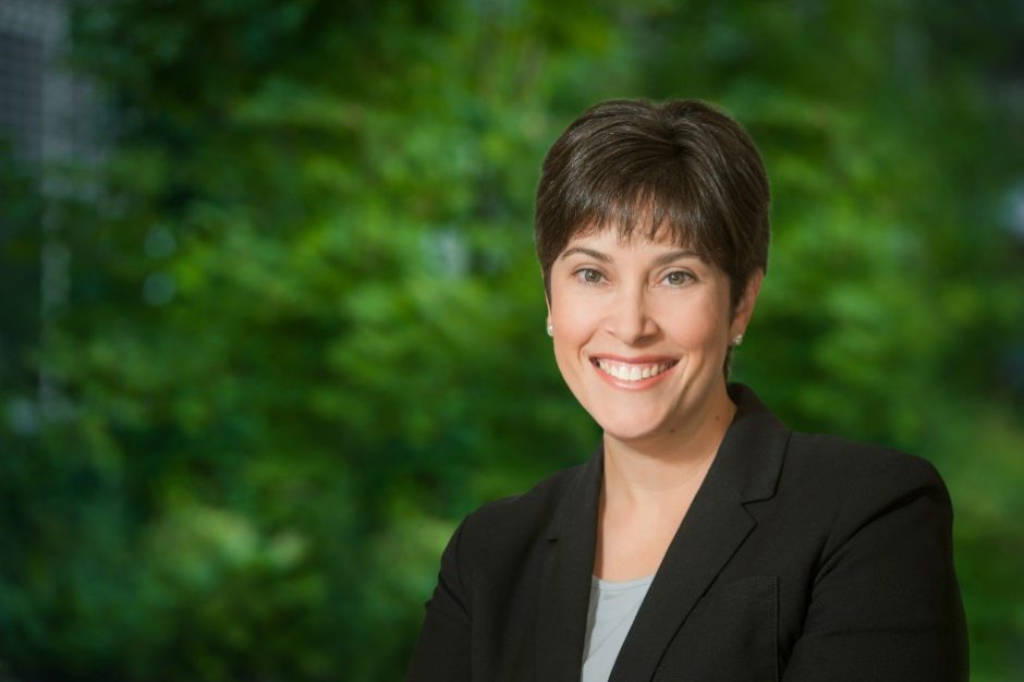 A headshot of Dr. Suzanne Huot with a forested backdrop