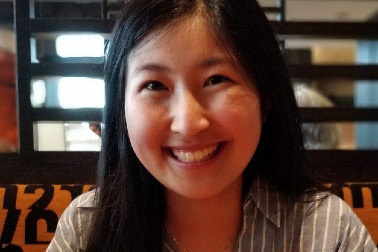 A picture of Christine Hsin smiling, whilst seated in a restaurant