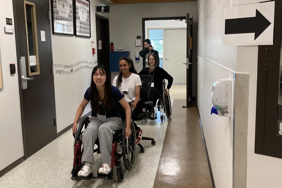 Participants in the 2023 D'HoPE program experiencing wheelchairs as part of OT Day