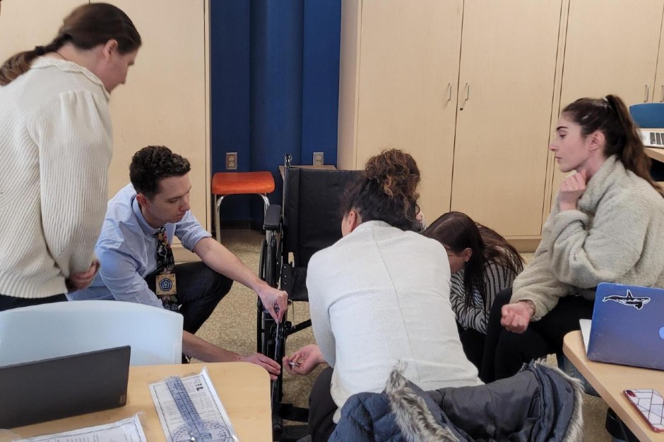 Students studying wheelchair measurements in a classroom